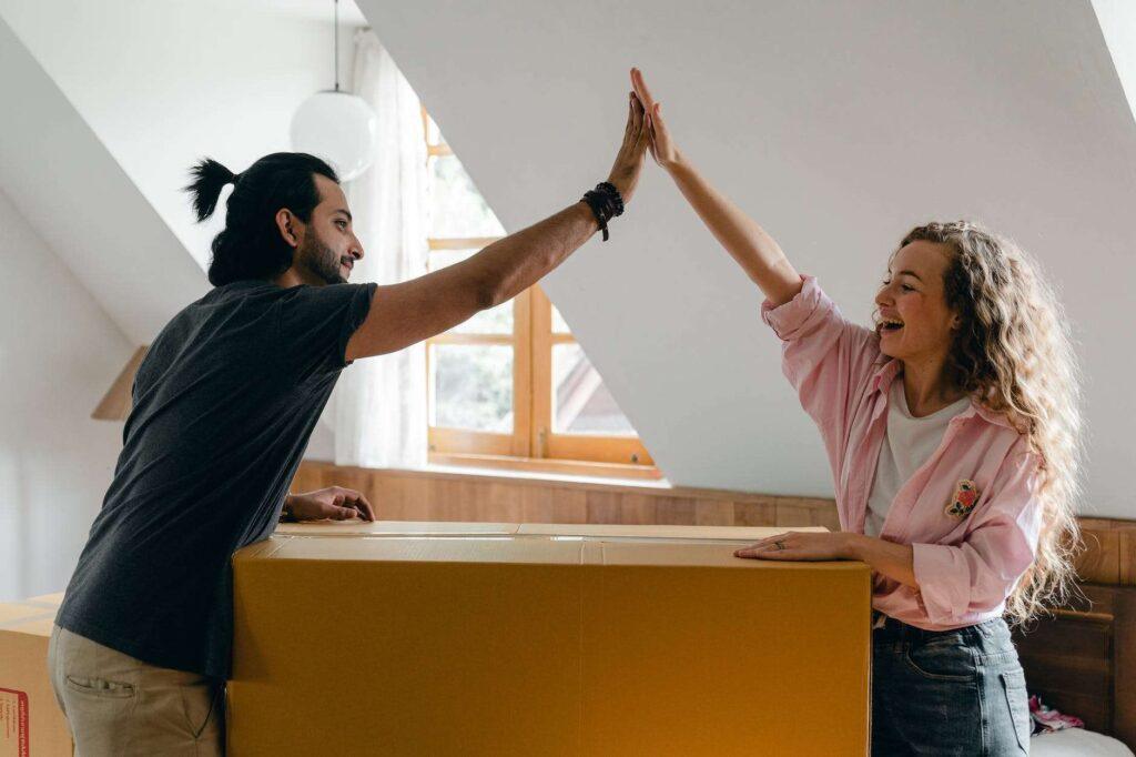 exited diverse couple relocating in new apartment