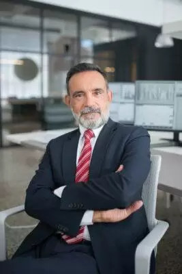 man in black suit sitting on white chair