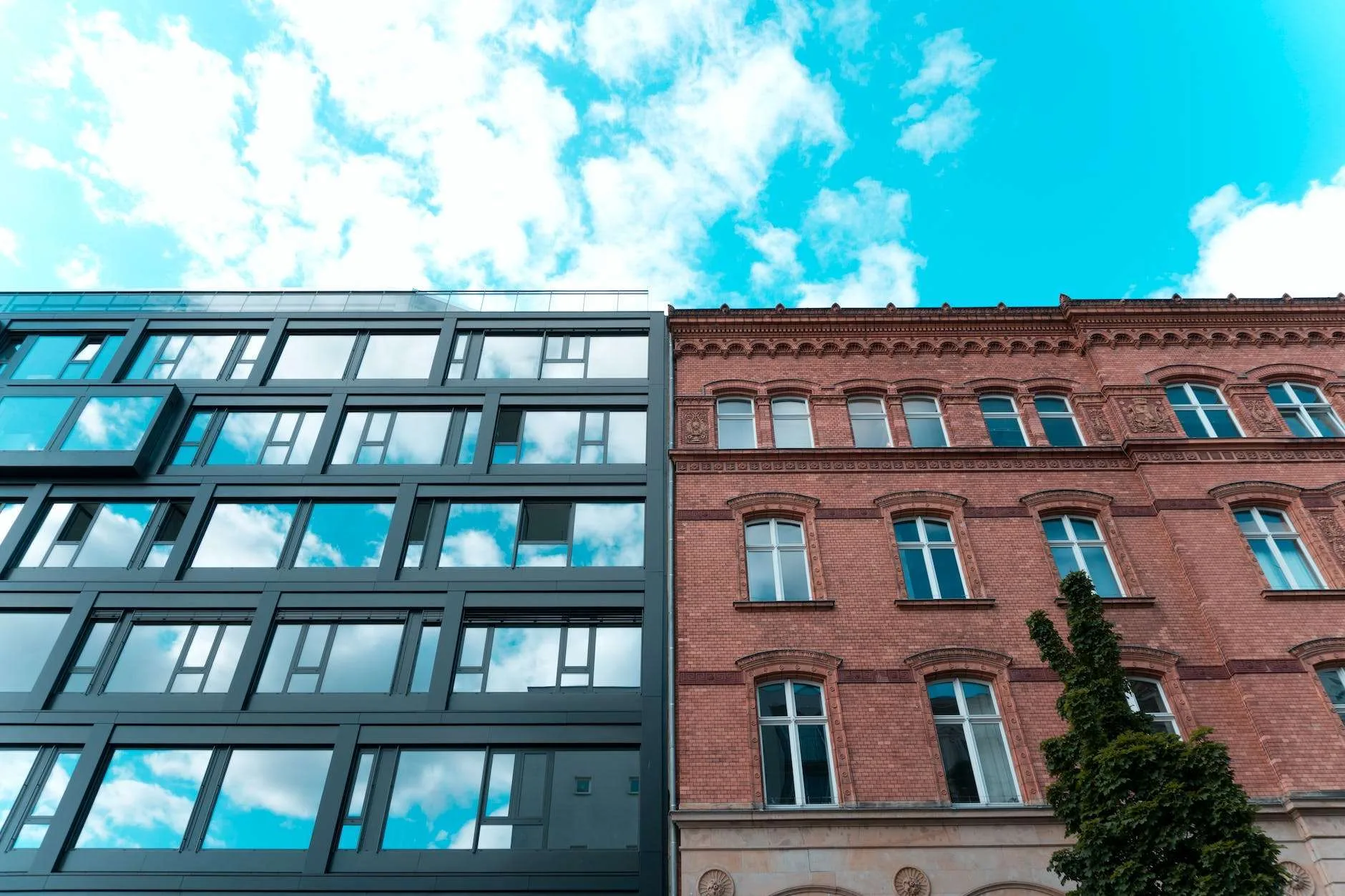 low angle photo of two adjacent apartment buildings